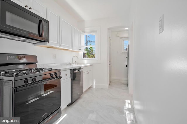 3917 Ridgewood Ave, Baltimore, MD 21215 - kitchen with gas stove, black microwave, stainless steel dishwasher, and white cabinetry