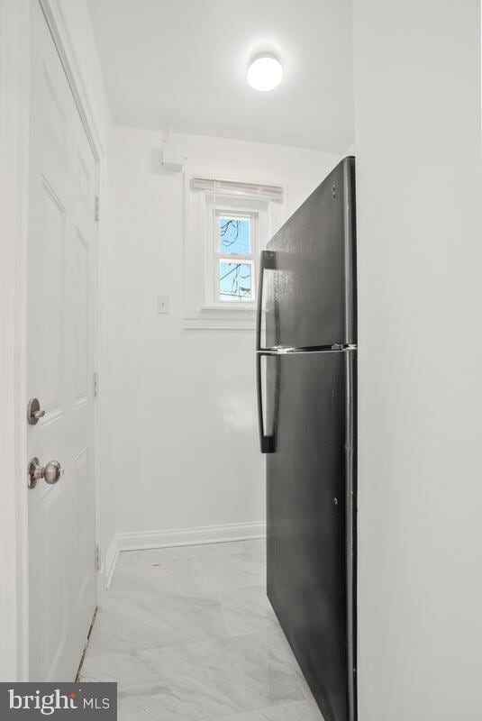 3917 Ridgewood Ave, Baltimore, MD 21215 - kitchen featuring baseboards, light marble finish floors, and freestanding refrigerator