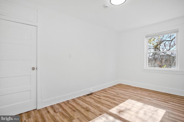 unfurnished room with hardwood / wood-style flooring