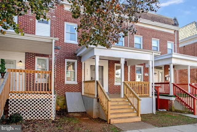 3917 Ridgewood Ave, Baltimore, MD 21215 - townhome / multi-family property featuring brick siding and covered porch