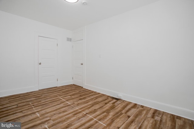 empty room featuring wood-type flooring