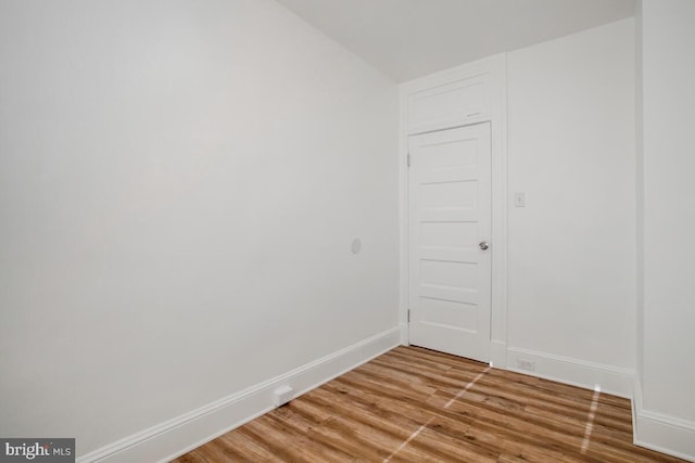 unfurnished room with wood-type flooring