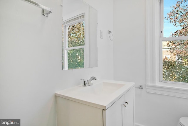 bathroom featuring vanity and toilet