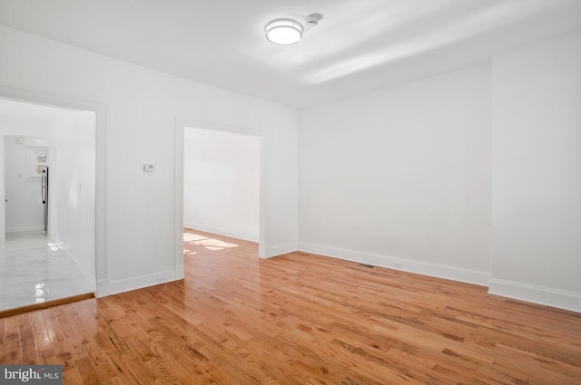 empty room with light hardwood / wood-style floors