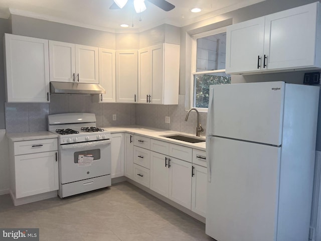 kitchen with white appliances, ceiling fan, crown molding, sink, and white cabinetry