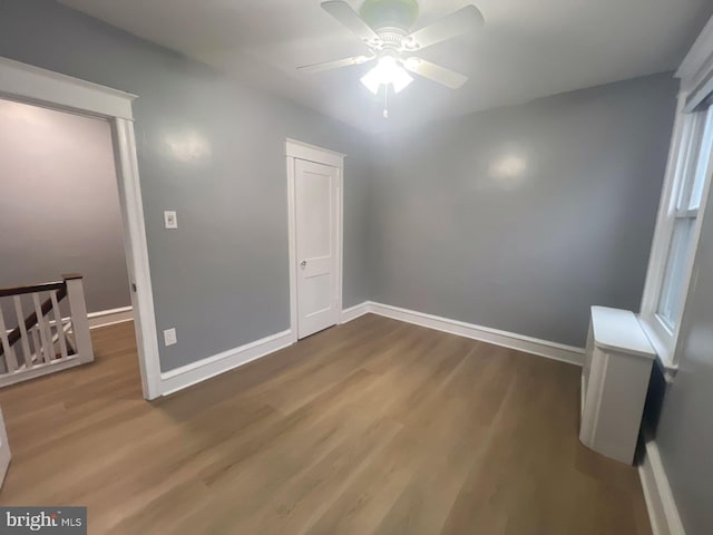 empty room with hardwood / wood-style flooring and ceiling fan