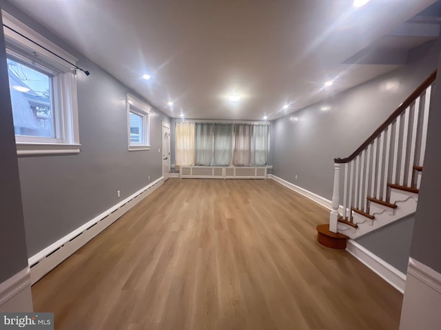 interior space with light hardwood / wood-style floors, radiator, baseboard heating, and a wealth of natural light