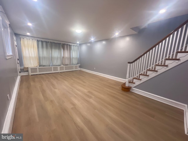 interior space with radiator and hardwood / wood-style floors