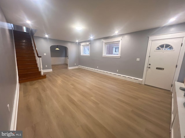 basement with baseboard heating and wood-type flooring