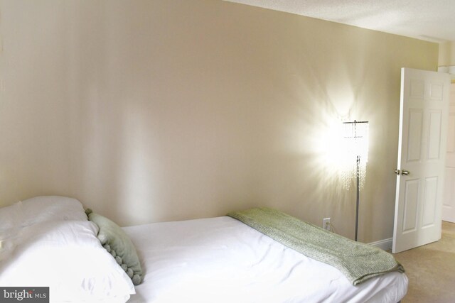 carpeted bedroom featuring a textured ceiling