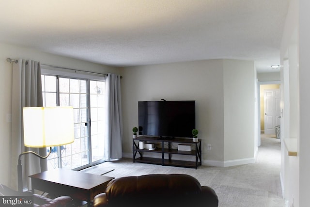 living room featuring light carpet and a textured ceiling