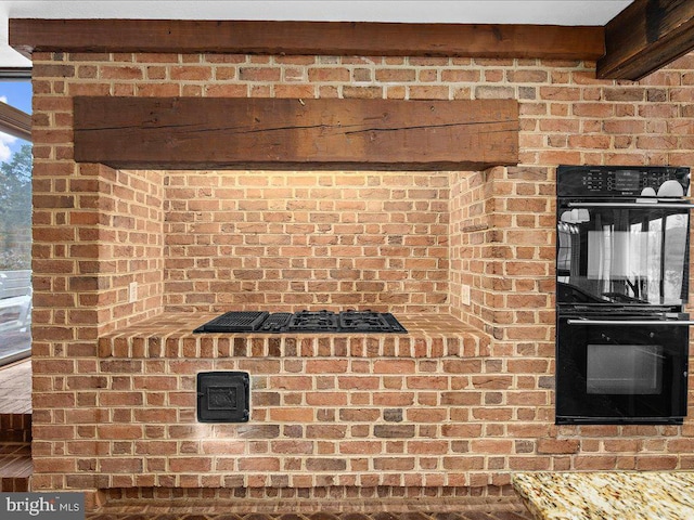 details with black double oven and light stone counters