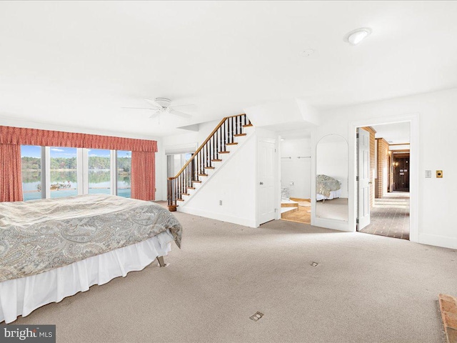 carpeted bedroom featuring connected bathroom and ceiling fan