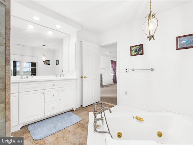 bathroom with a bathtub, vanity, and tile patterned flooring