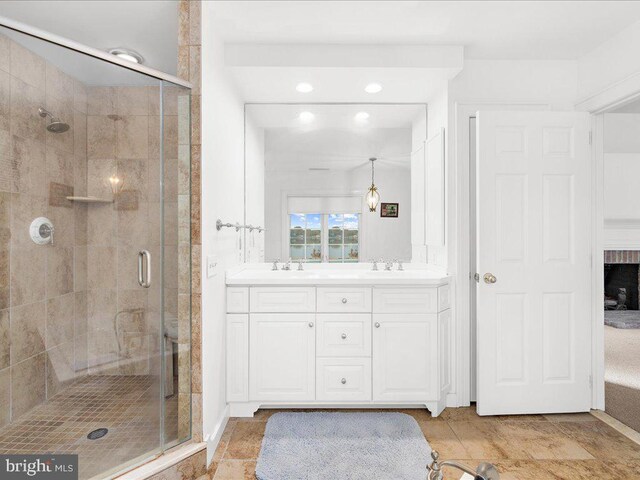 bathroom featuring vanity and an enclosed shower