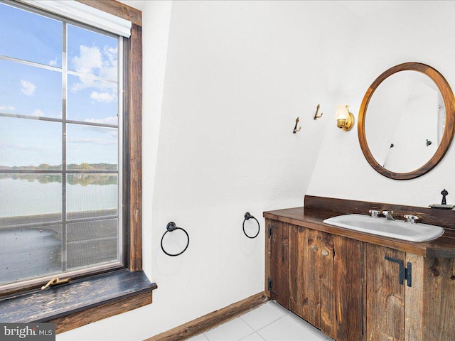 bathroom featuring vanity, a water view, and tile patterned floors