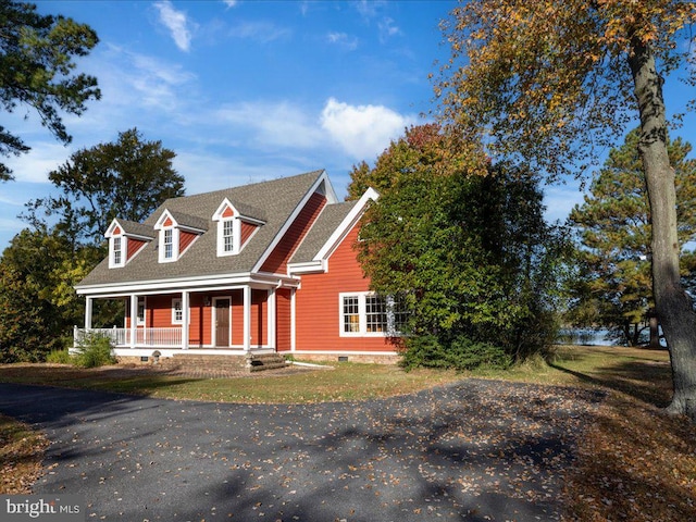 cape cod home featuring a porch