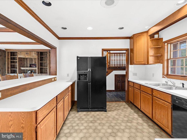 kitchen with sink, backsplash, ornamental molding, and black appliances