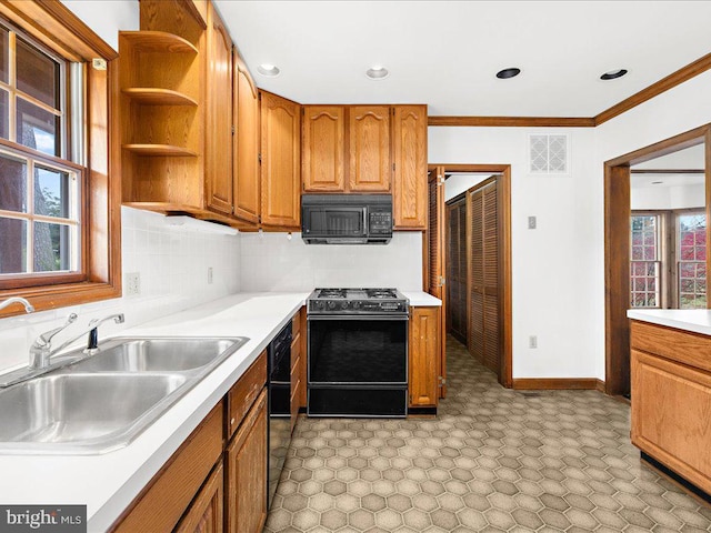 kitchen with black appliances, crown molding, sink, and a wealth of natural light