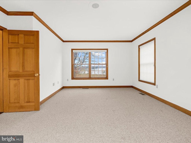 unfurnished room featuring crown molding and light colored carpet