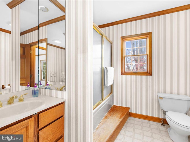 full bathroom featuring combined bath / shower with glass door, vanity, toilet, and ornamental molding