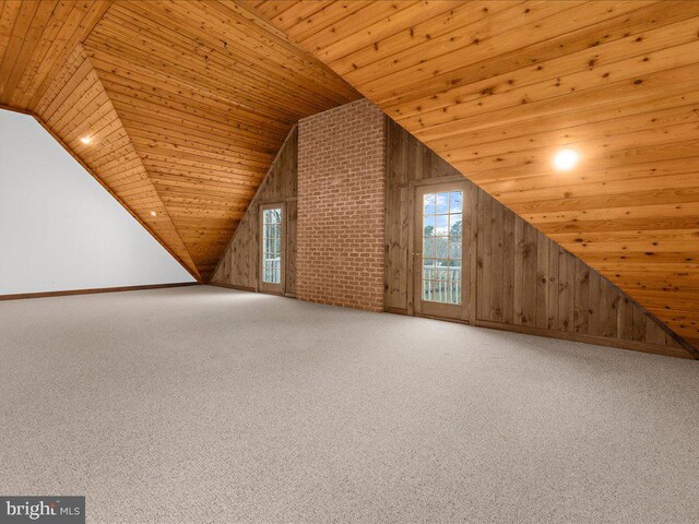 additional living space with wooden walls, carpet, and wood ceiling