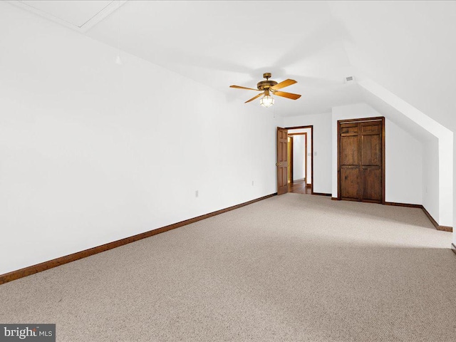 additional living space with carpet, vaulted ceiling, and ceiling fan