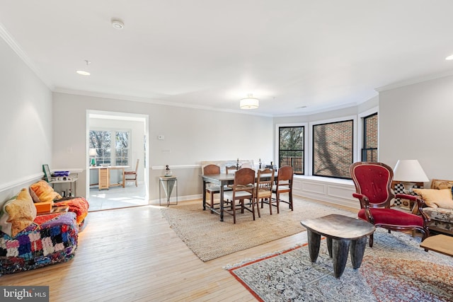 living room with light hardwood / wood-style floors, plenty of natural light, and ornamental molding