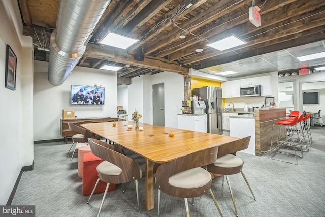 dining room with carpet floors and sink