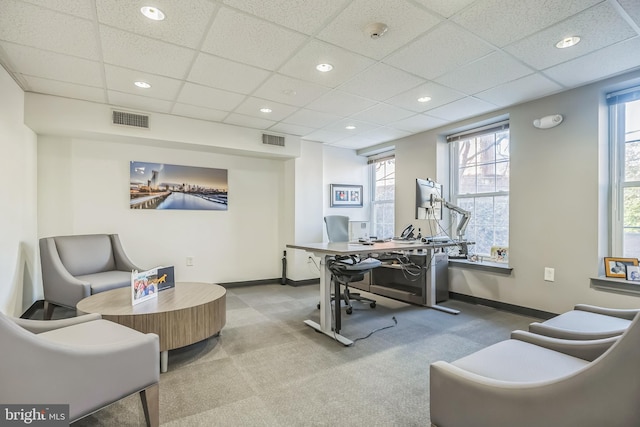 office space with carpet floors, a wealth of natural light, and a paneled ceiling