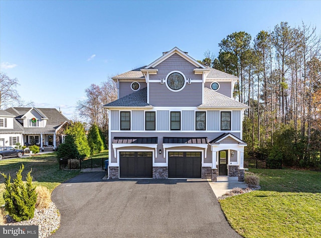 view of front of property featuring a garage and a front lawn