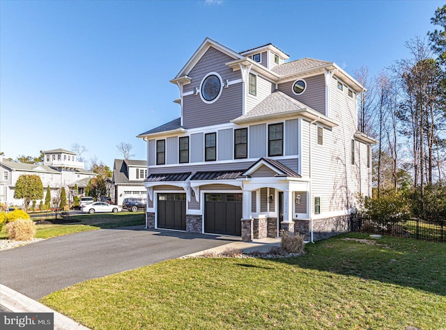 view of front of property with a front yard and a garage