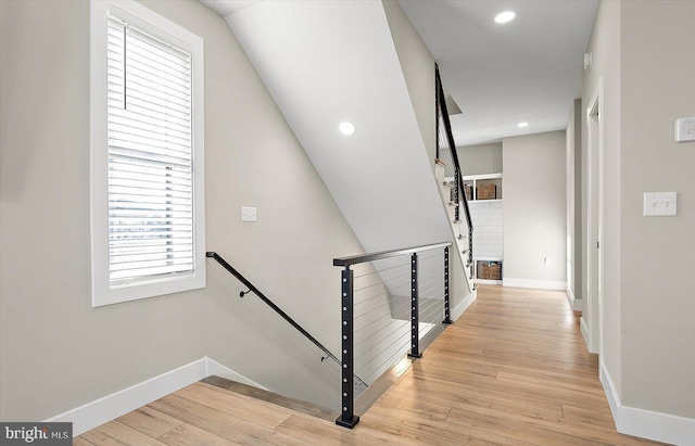 staircase with hardwood / wood-style flooring