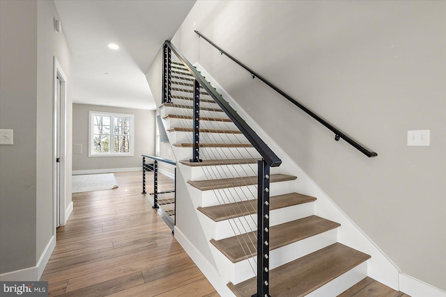 staircase featuring hardwood / wood-style floors