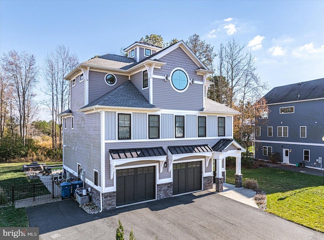 view of front of property with a garage and a front lawn