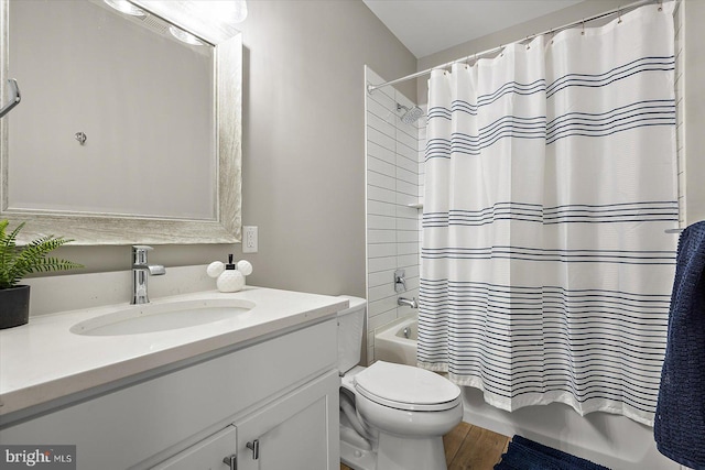 full bathroom featuring wood-type flooring, vanity, toilet, and shower / bath combo with shower curtain