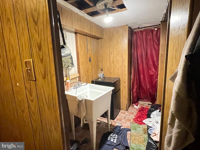 laundry area featuring wooden walls