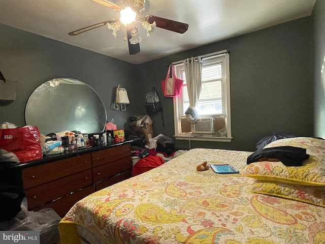 bedroom with ceiling fan and cooling unit