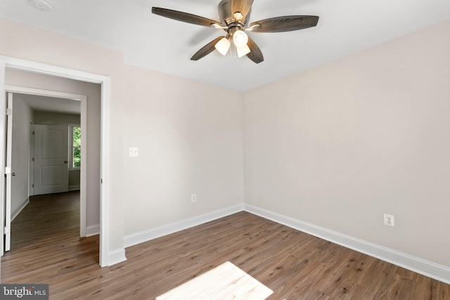 empty room with hardwood / wood-style floors and ceiling fan