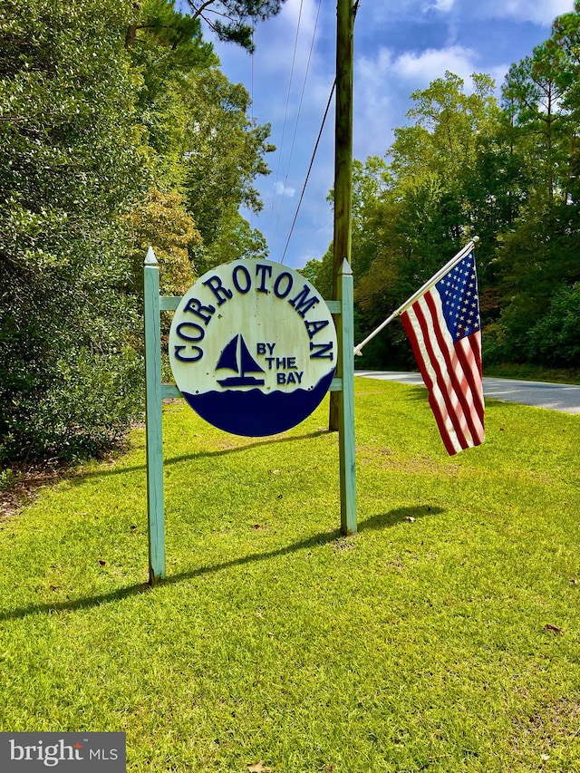 community / neighborhood sign with a lawn