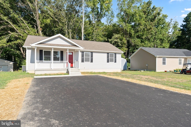 view of front of home with a front yard and a porch