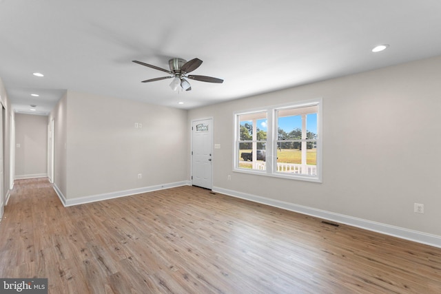 spare room with light hardwood / wood-style flooring and ceiling fan