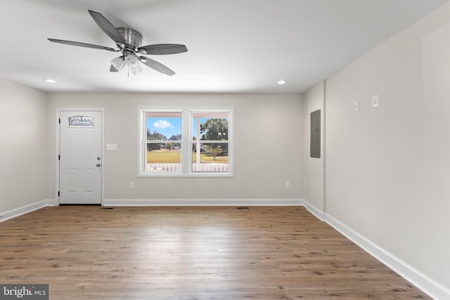 foyer entrance featuring ceiling fan, electric panel, and light hardwood / wood-style floors