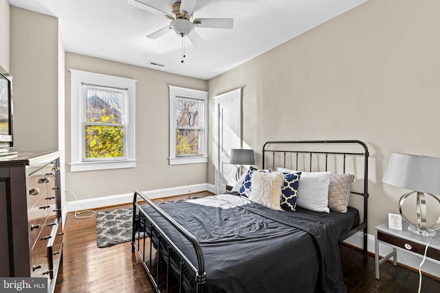 bedroom featuring ceiling fan and dark wood-type flooring