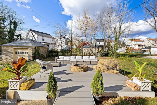 wooden terrace featuring an outdoor living space with a fire pit