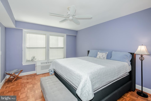 bedroom featuring parquet floors, radiator heating unit, and ceiling fan
