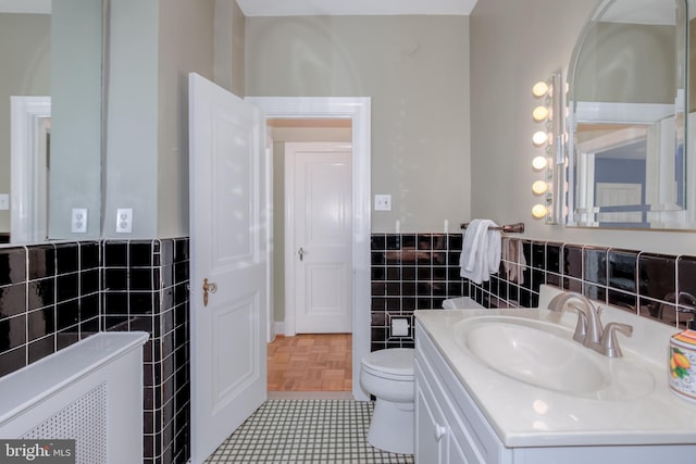 bathroom with tile patterned flooring, vanity, and toilet