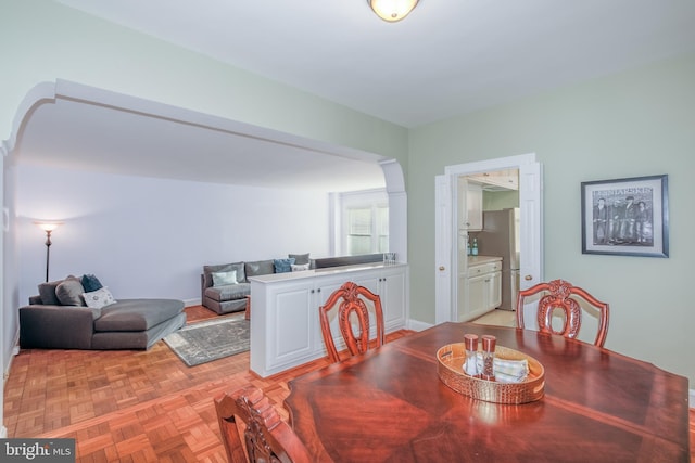 dining space featuring light parquet flooring