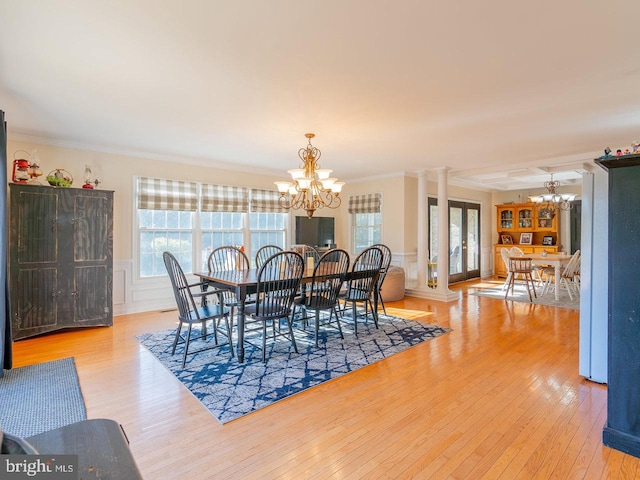 dining space featuring decorative columns, light hardwood / wood-style flooring, plenty of natural light, and crown molding