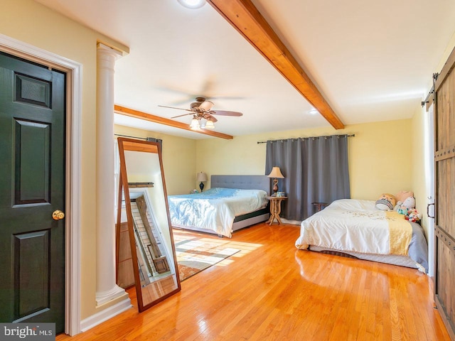 bedroom with hardwood / wood-style flooring, ceiling fan, and beamed ceiling